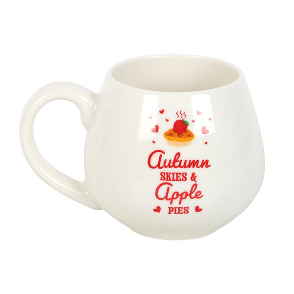 White ceramic fall mug with red and green Autumn Skies & Apple Pies lettering – Panache Homeware Kitchen Collection, cozy autumn coffee cup, perfect gift.