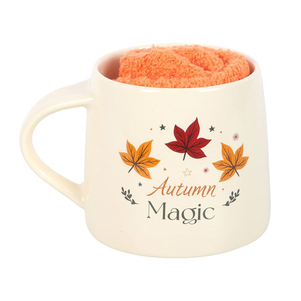 White ceramic mug with Autumn Magic text and leaf pattern paired with orange socks – Panache Homeware Kitchen Collection, rustic fall coffee gift set, perfect gift idea.
