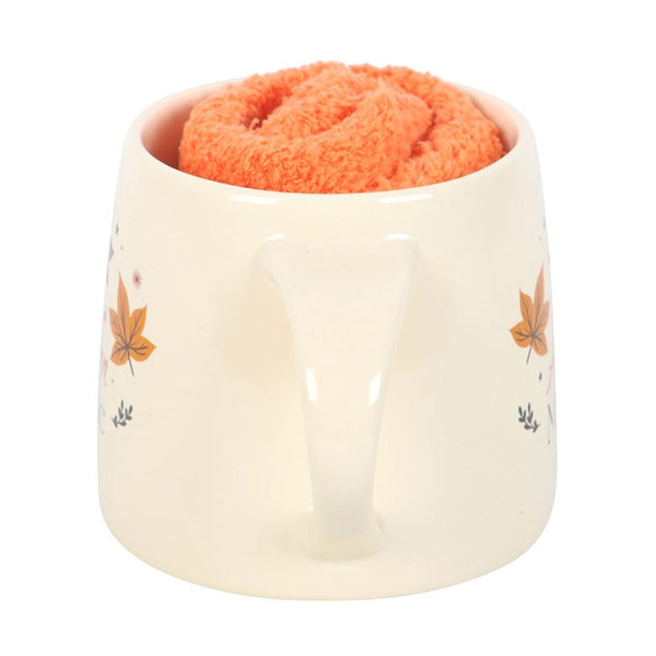 White ceramic Autumn Magic mug with fall leaf print and orange socks – Panache Homeware Kitchen Collection, cozy autumn tea and coffee set, perfect gift