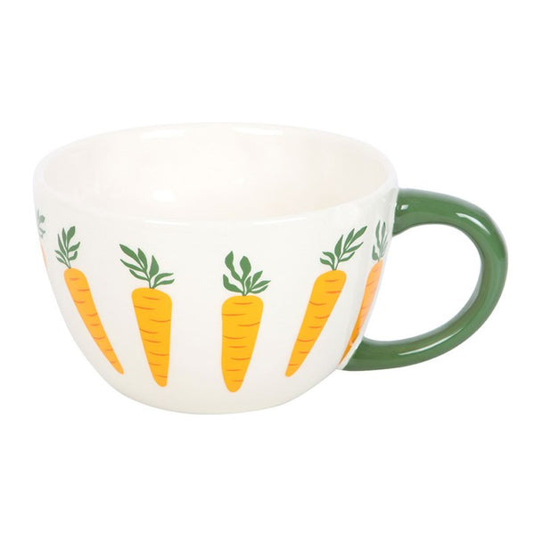 White mug with green handle and carrot design on a white background