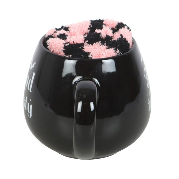 Black mug with a pink and black socks as a perfect gift set  