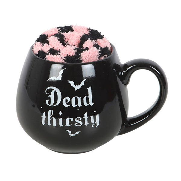 Black mug with 'Dead thirsty' text and bat design, filled with pink and black marshmallow bats.