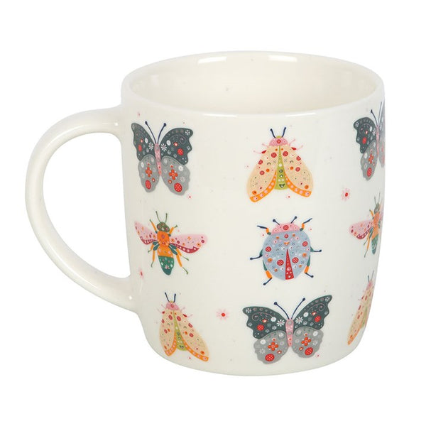 White ceramic mug with colorful butterfly and bee pattern – Panache Homeware Kitchen Collection, whimsical cottagecore coffee cup.