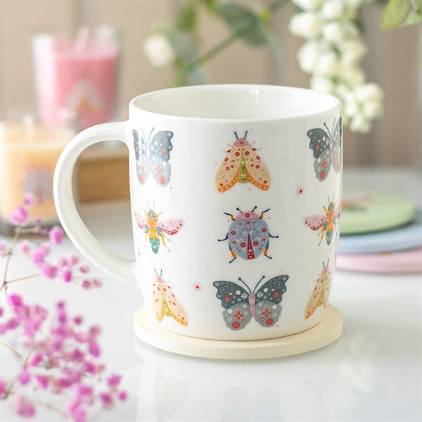 White ceramic mug with floral bug print featuring butterflies and beetles – Panache Homeware Kitchen Collection, whimsical cottagecore coffee cup