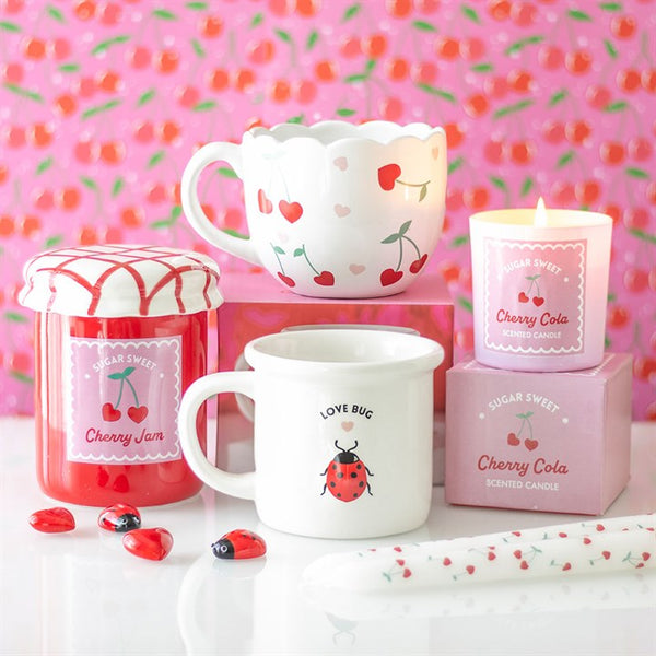 Cherries and cherry-themed kitchen products on pink background – Panache Homeware Kitchen Collection, cute cottagecore kitchen gifts.