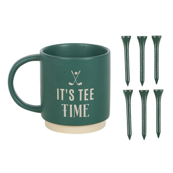Green mug with 'It's Tee Time' text and golf tees on a white background