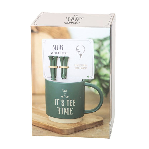 Green mug with golf tees in packaging.