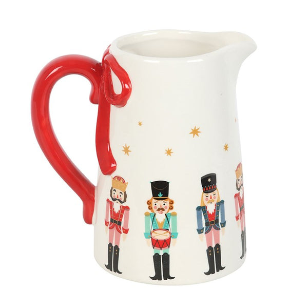 Nutcracker ceramic flower jug with red bow detail, ideal for displaying flowers or as festive Christmas table décor.