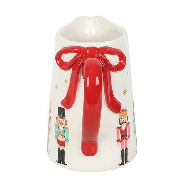 Nutcracker ceramic flower jug with red bow detail, ideal for displaying flowers or as festive Christmas table décor.