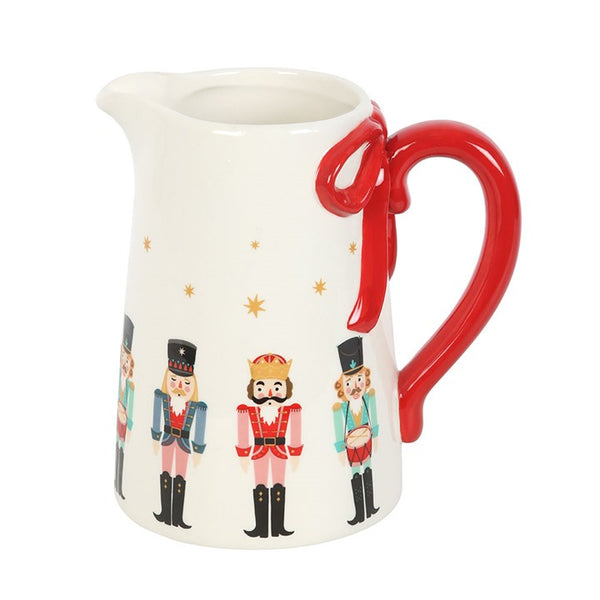 Nutcracker ceramic flower jug with red bow detail, ideal for displaying flowers or as festive Christmas table décor.