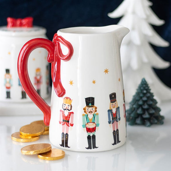 Nutcracker ceramic flower jug with red bow detail, ideal for displaying flowers or as festive Christmas table décor.