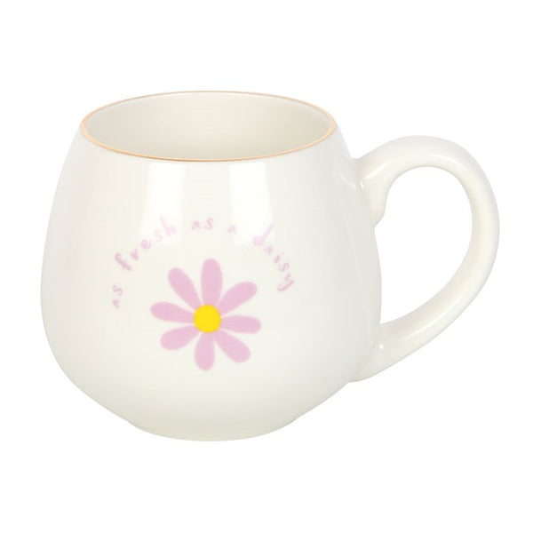 White mug with pink daisy design on a white background