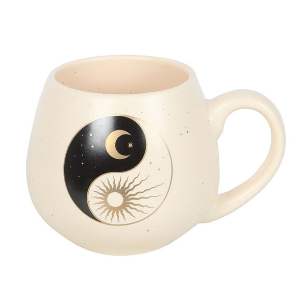 Beige mug with yin yang design on a white background