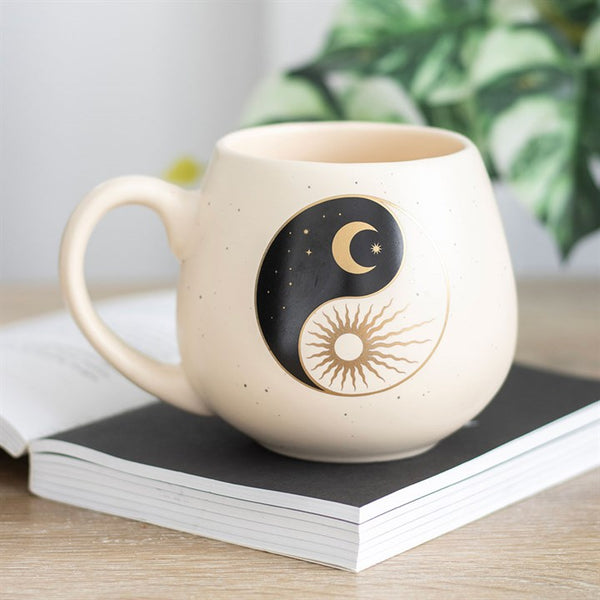 Beige ceramic mug with black yin yang, sun and crescent moon design – Panache Homeware Kitchen Collection, mystical cottagecore coffee cup.