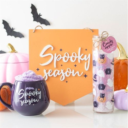 Halloween-themed gift set with mugs, candle, and decorative box.
