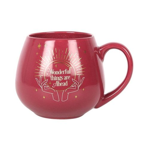 Red mug with decorative handle and text on a white background