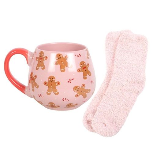 Pink mug with gingerbread men pattern and matching pink socks on a white background