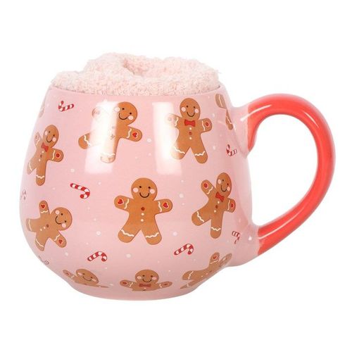 Pink mug with gingerbread man pattern on a white background